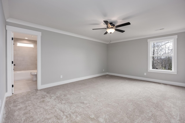 carpeted empty room featuring ceiling fan, baseboards, and ornamental molding