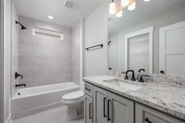 bathroom featuring vanity, visible vents, tile patterned floors, toilet, and shower / bathtub combination