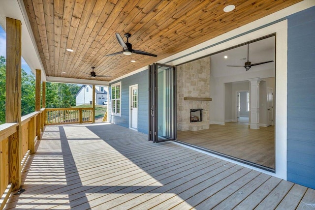 wooden terrace featuring ceiling fan