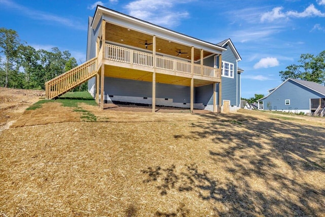 rear view of house with a wooden deck and ceiling fan