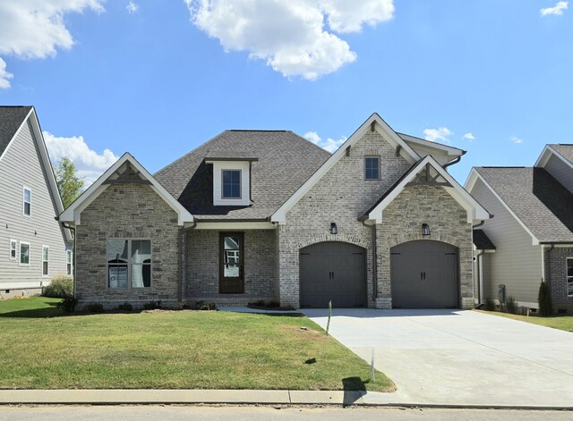 view of front of home featuring a front yard and a garage