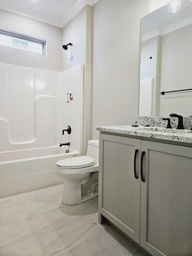 bathroom featuring washtub / shower combination, toilet, vanity, and ornamental molding