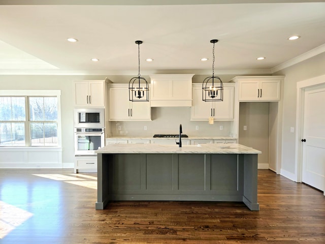 kitchen with oven, dark hardwood / wood-style flooring, light stone countertops, a center island with sink, and white cabinets