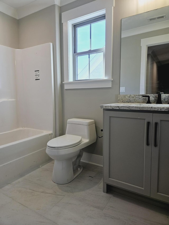 bathroom with toilet, marble finish floor, baseboards, bathing tub / shower combination, and vanity