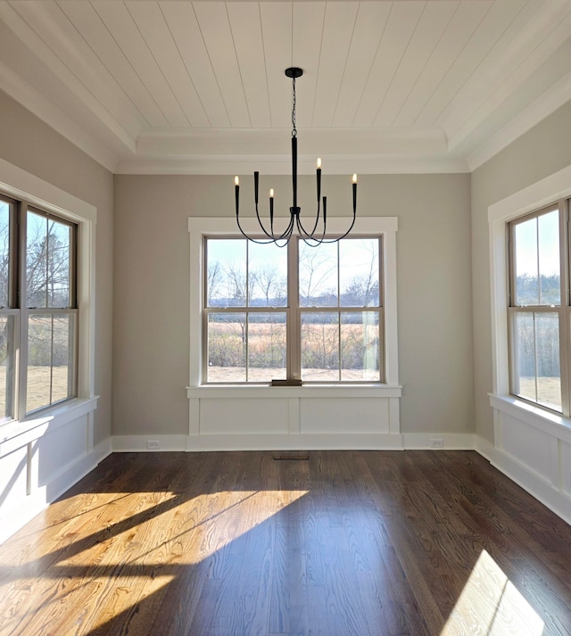 unfurnished dining area with a wealth of natural light, a chandelier, and dark hardwood / wood-style floors