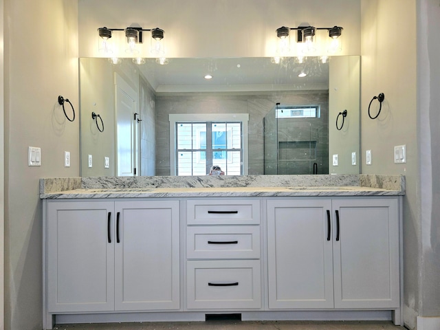 bathroom with vanity and a shower with shower door