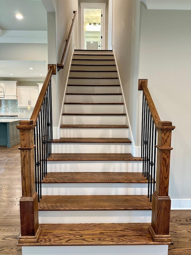 staircase featuring wood-type flooring