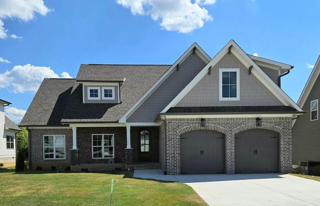 craftsman-style home featuring cooling unit, a garage, and a front yard