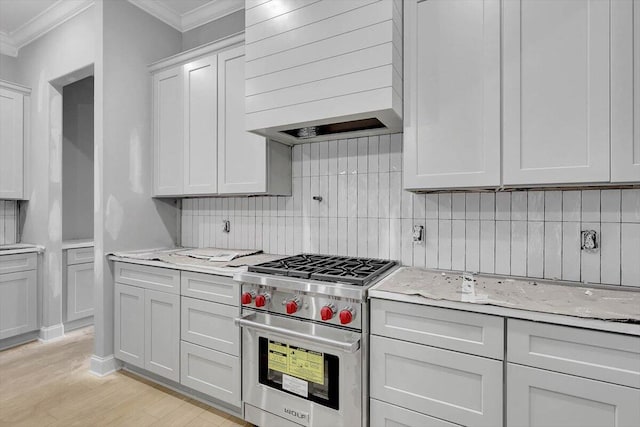 kitchen with light hardwood / wood-style floors, decorative backsplash, designer stove, crown molding, and light stone countertops