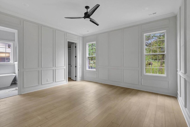 empty room featuring light hardwood / wood-style floors, ceiling fan, and plenty of natural light