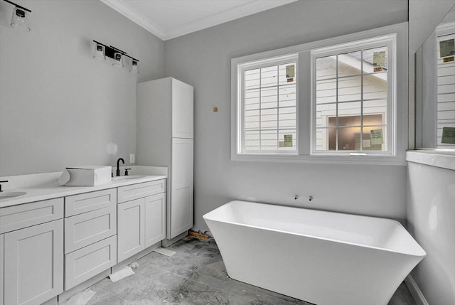 bathroom featuring vanity, ornamental molding, and a bath