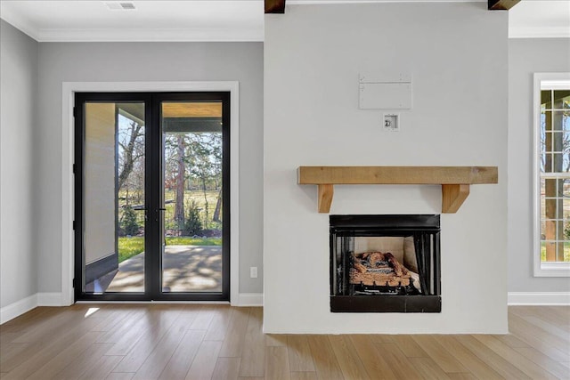 interior space with crown molding, hardwood / wood-style floors, and french doors