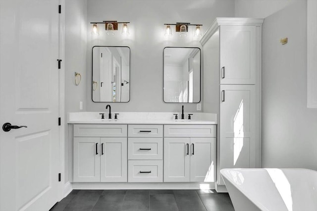 bathroom featuring vanity, a bath, and tile patterned floors