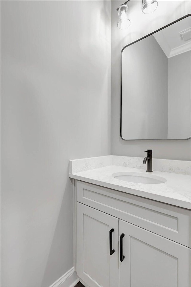 bathroom featuring vanity and crown molding