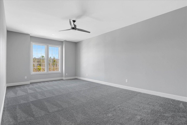 unfurnished room featuring ceiling fan and dark carpet