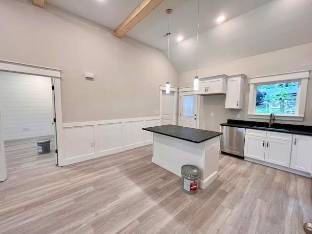 kitchen featuring a center island, white cabinets, sink, hanging light fixtures, and stainless steel dishwasher