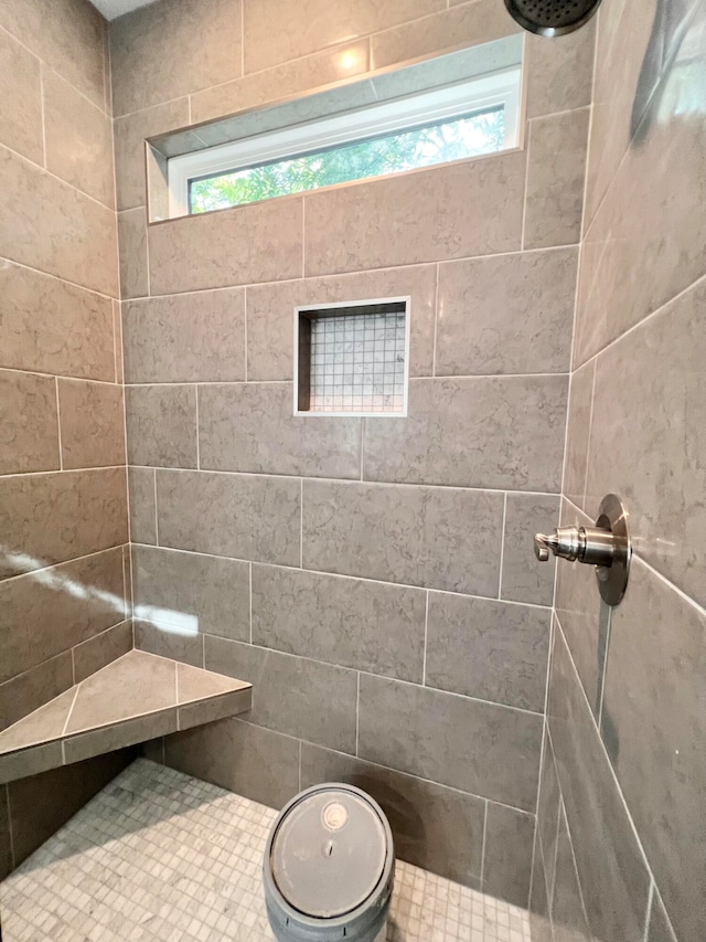 bathroom with tiled shower