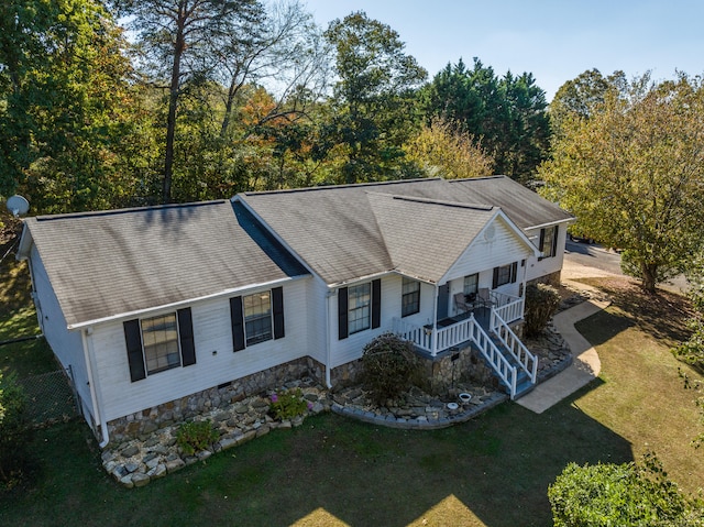 ranch-style house with a front yard and a porch