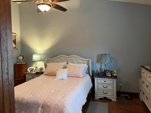 bedroom featuring dark hardwood / wood-style flooring and ceiling fan