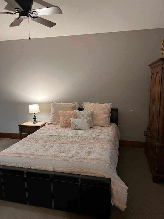 bedroom with ceiling fan and dark colored carpet