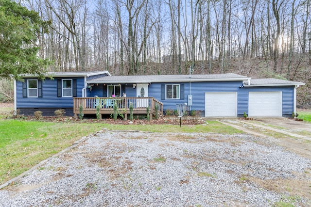 single story home featuring a garage and a wooden deck