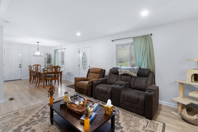 living room featuring light hardwood / wood-style floors and a chandelier