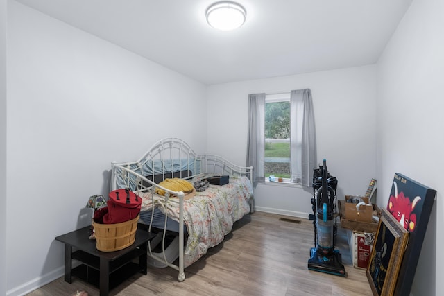 bedroom with hardwood / wood-style flooring