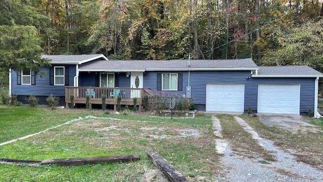 ranch-style home with a garage, a front yard, and a deck