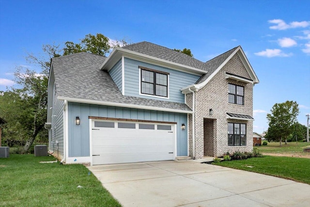 view of front facade with a garage, a front lawn, and central AC