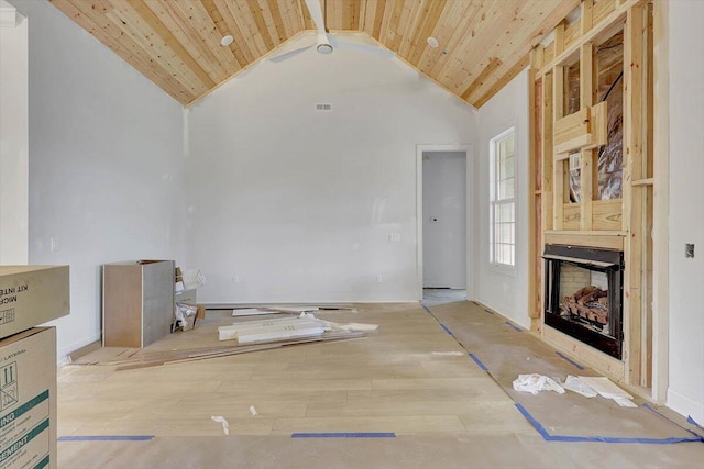 unfurnished living room with ceiling fan, beamed ceiling, wood ceiling, and light hardwood / wood-style flooring