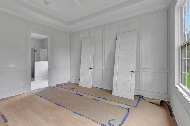 unfurnished bedroom with ornamental molding and light hardwood / wood-style floors