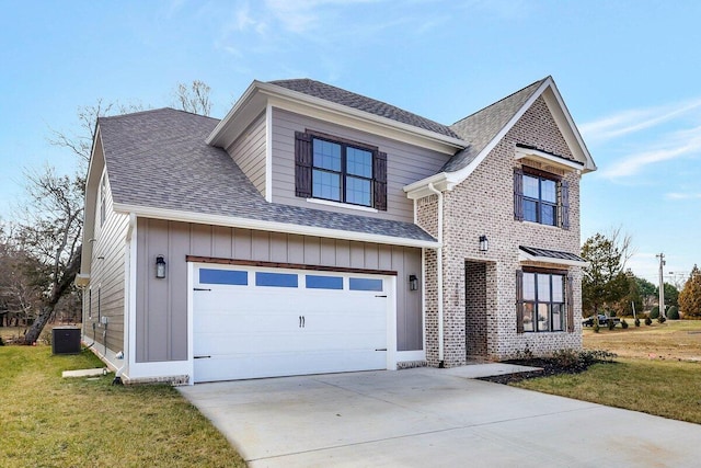 view of front facade with a garage, a front lawn, and central air condition unit