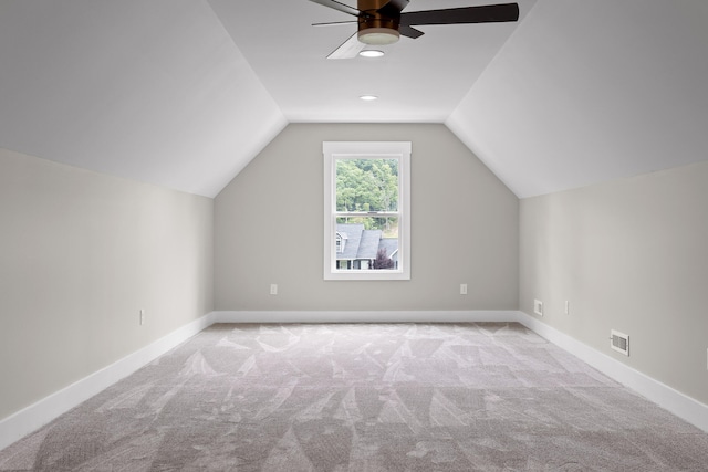 bonus room featuring ceiling fan, light colored carpet, and lofted ceiling