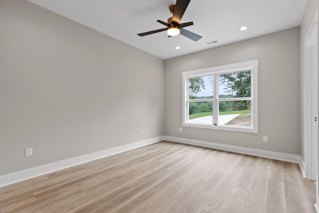 spare room with ceiling fan and light wood-type flooring