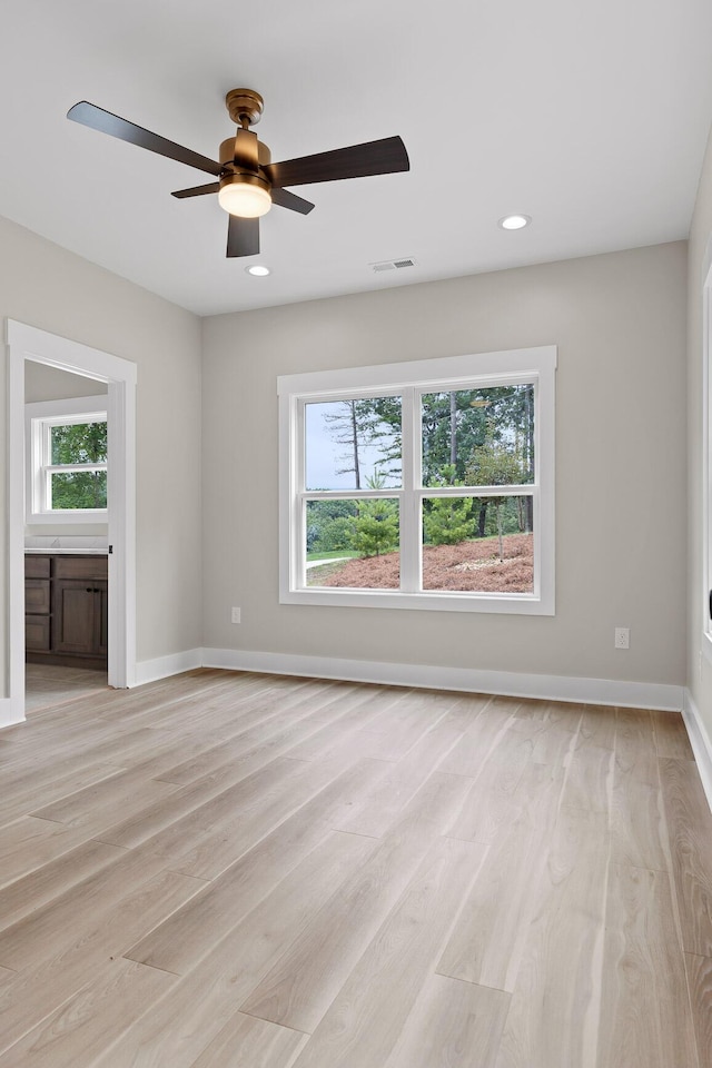 empty room featuring light hardwood / wood-style flooring and ceiling fan