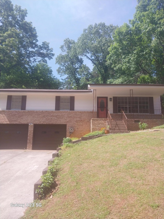 view of front of home with a garage and a front lawn