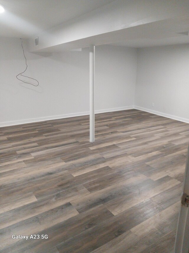 basement featuring dark hardwood / wood-style floors