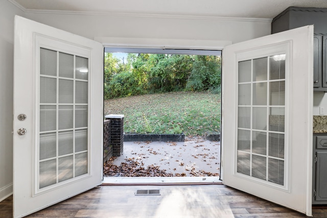 doorway to outside with crown molding and dark hardwood / wood-style flooring