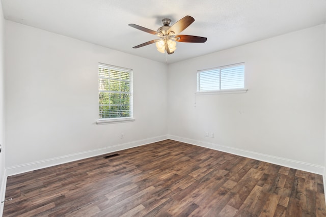 empty room featuring ceiling fan and dark hardwood / wood-style floors