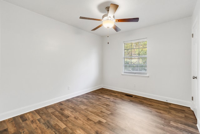 empty room with dark hardwood / wood-style floors and ceiling fan