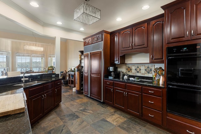 kitchen featuring ornamental molding, double oven, sink, a notable chandelier, and stovetop