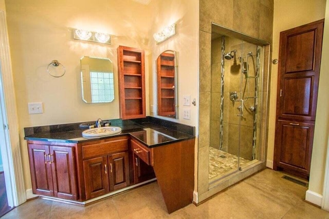 bathroom featuring tile patterned floors, vanity, and an enclosed shower