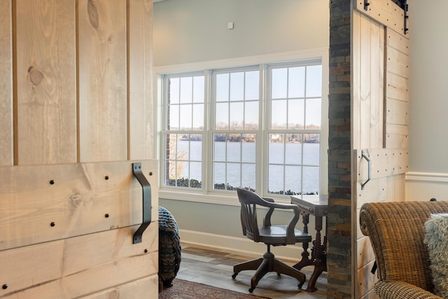 living area with a water view and wood-type flooring