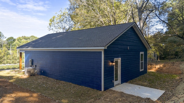 view of home's exterior with central AC unit and an outdoor structure