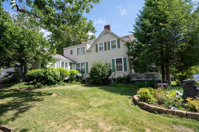 view of front of home featuring a front lawn and a chimney