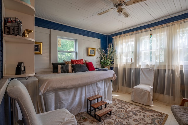 bedroom with ceiling fan, tile patterned flooring, and wooden ceiling