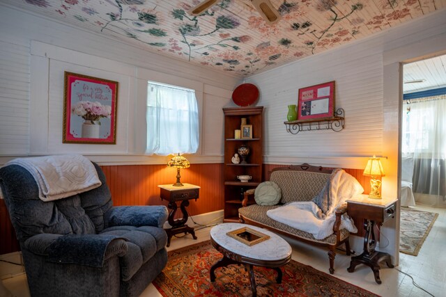 living room with wood-type flooring and wooden walls