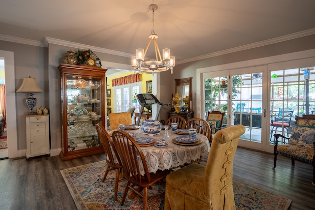 dining area featuring a healthy amount of sunlight, crown molding, a chandelier, and dark hardwood / wood-style flooring