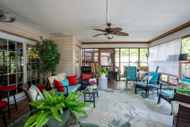 sunroom / solarium featuring ceiling fan and a wealth of natural light