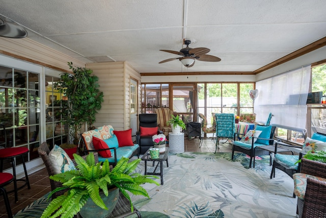 sunroom / solarium with an outdoor living space, a healthy amount of sunlight, and a ceiling fan